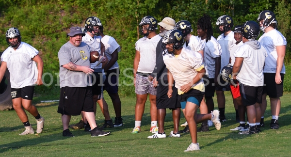 Coach Porter works with the defense